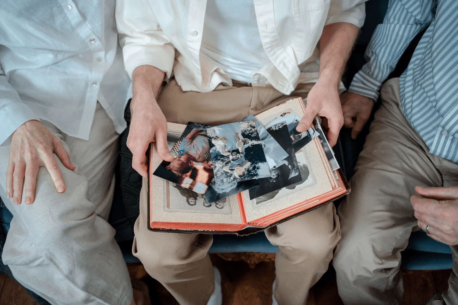 A family looking at old photos in a photo album together